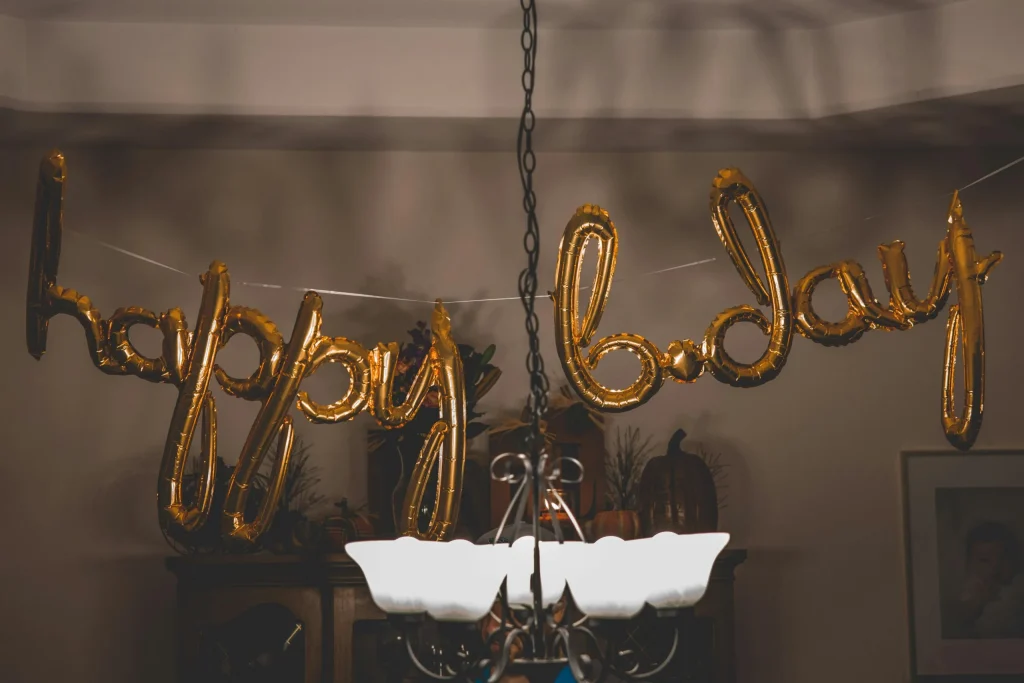 a gold balloons from a chandelier